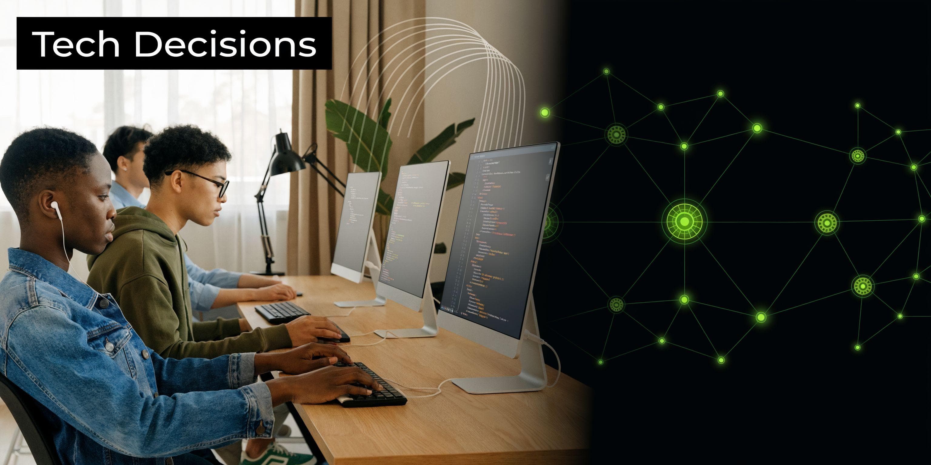 A group of young software developers collaborating on programming tasks at computer monitors in an office.