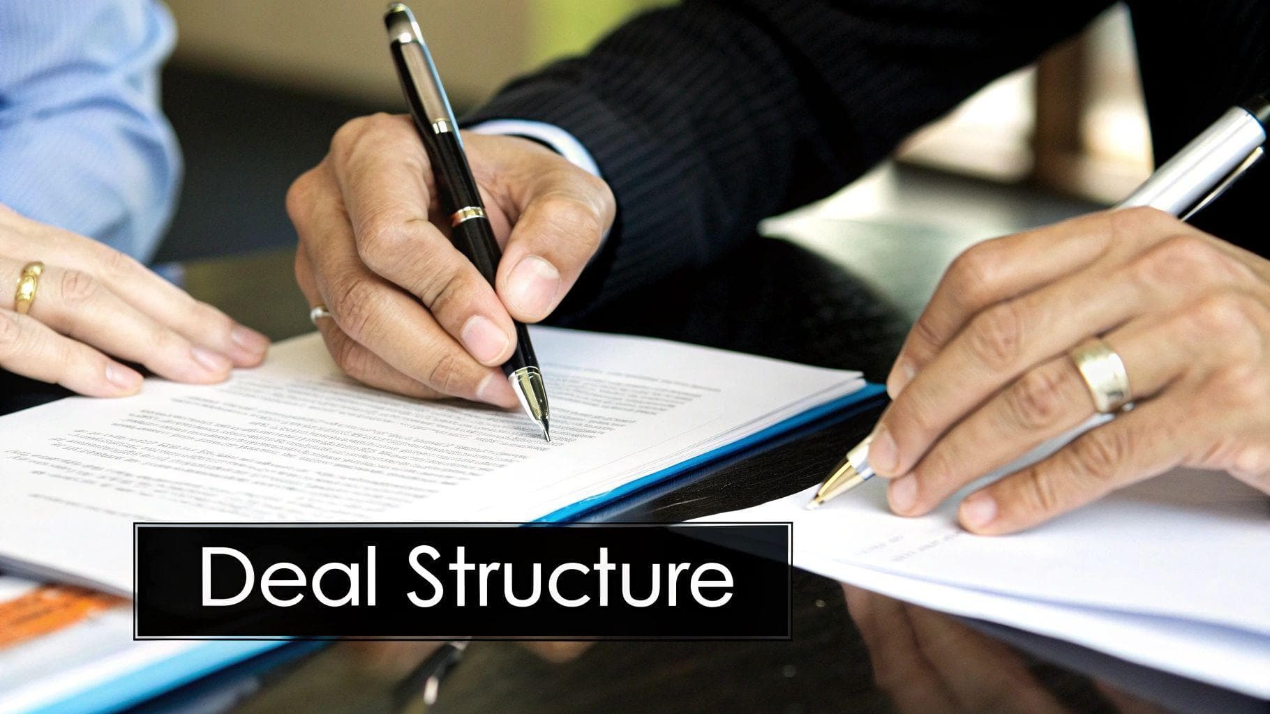 A modern building with large windows, reflecting the sky and surrounding trees.